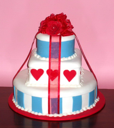 Red hearts and blue stripes three tier round wedding cake with red roses