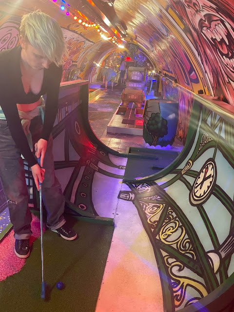 Young person playing Crazy Golf at Plonk Borough Market