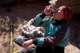 Kelly Bergdolt enjoying one of her rescued beers after her flip at Crystal, Colorado river, grand canyon Chris Baer