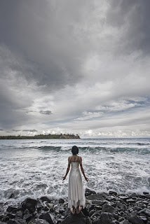 An image of a girl in the sea wearing a white color dress- sad girl dp