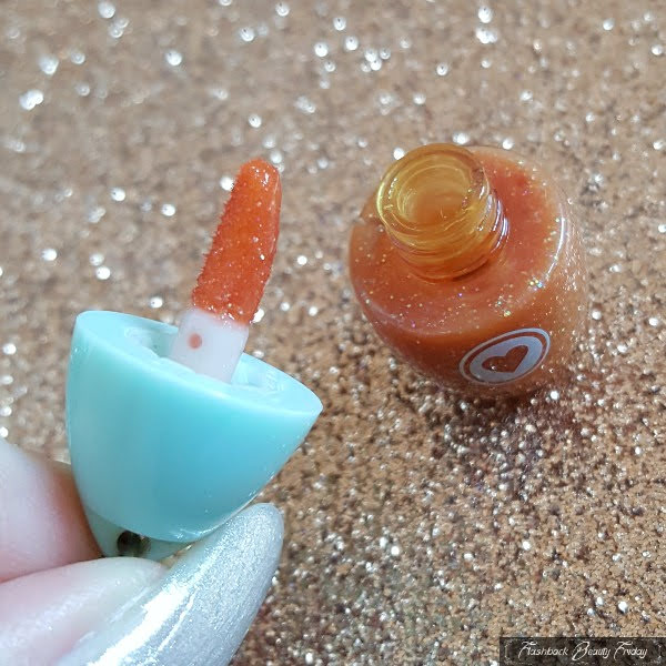 close up of miniature Hard Candy lipgloss charm with doefoot applicator