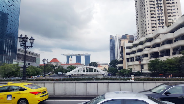 Marina Bay Sands in the distance seen from the free singapore tour bus while crossing coleman bridge