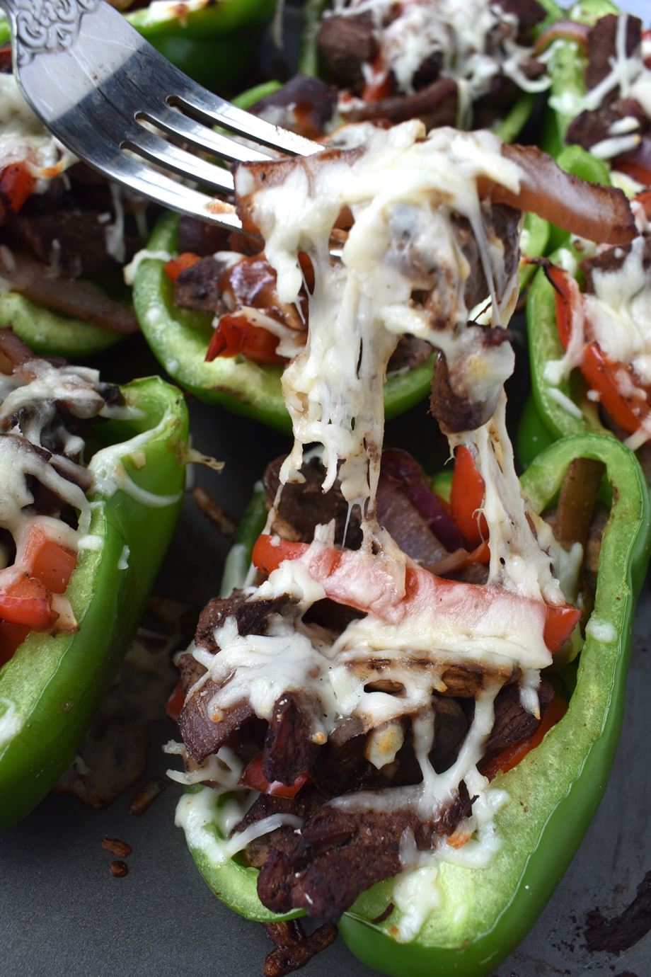 cheesy bite of Philly cheesesteak stuffed peppers