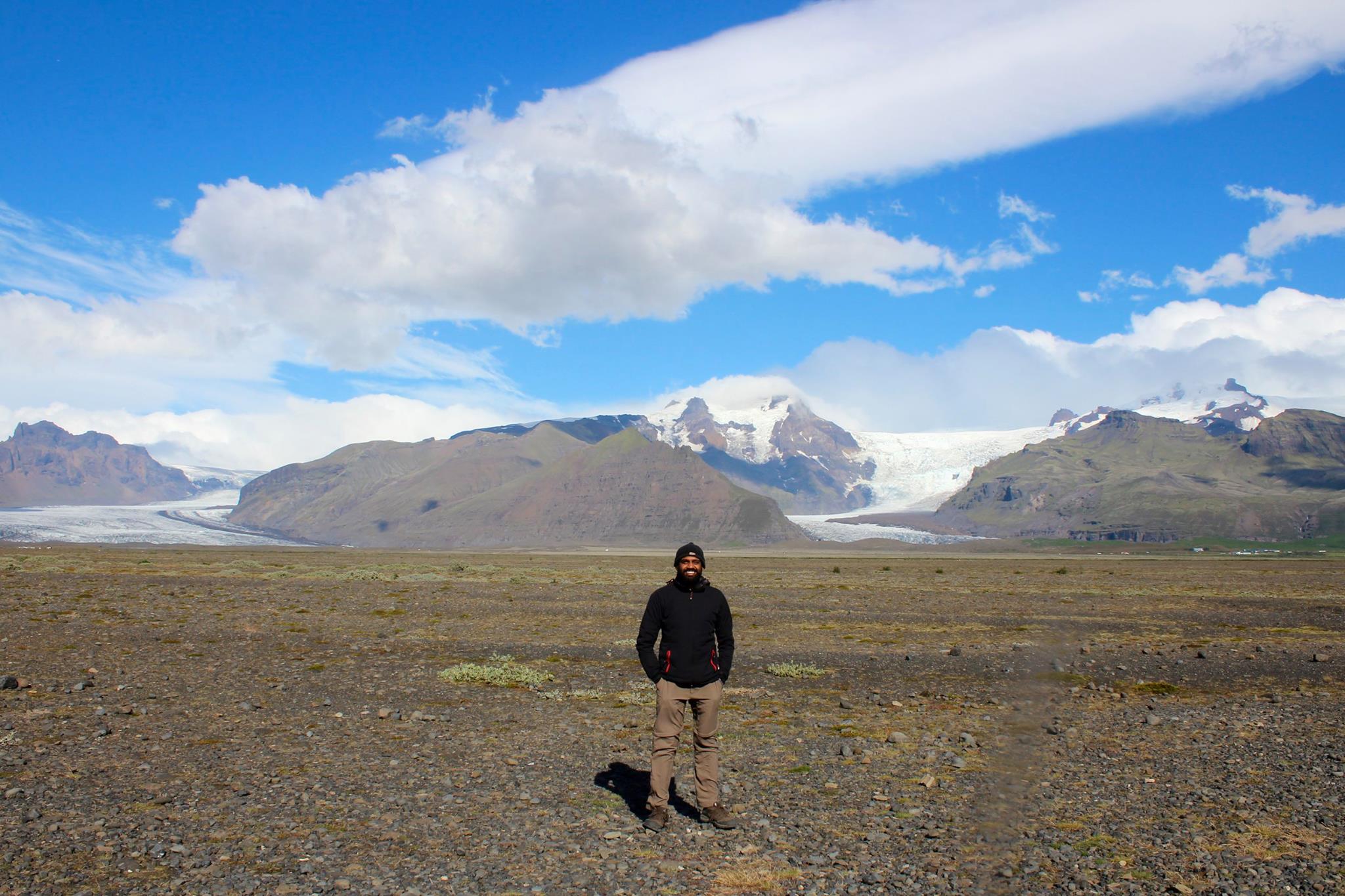 Sam standing in front of Hvannadalshnúkur peak and glacier