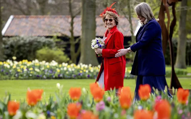 Dutch Princess Margriet is wearing a red wool coat by Max Mara, and red earrings. Garden of Europe or Keukenhof park