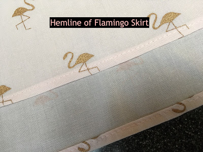 Flamingo skirt fabric with a 5/8 hem folded over twice and sewn.