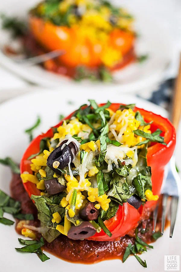 Vegetarian Stuffed Peppers with Orzo Pasta on a white serving plate ready to eat