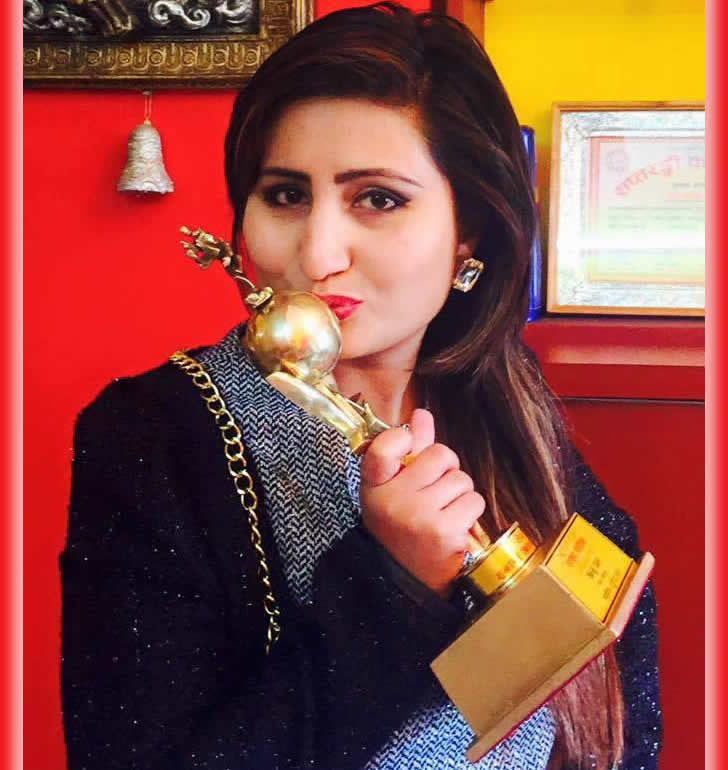 Anju Panta clinching Hits FM Award