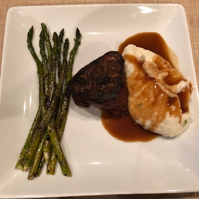 Bison filet mignon, mashed potatoes and gravy and grilled asparagus