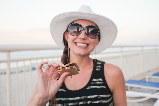 Amy West enjoying s'mores on the beach at The Shores Resort and Spa