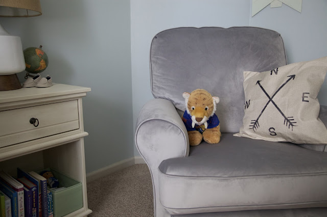 A travel and adventure-inspired gender neutral nursery with pops of burlap, pale gray, white, blue, and green.