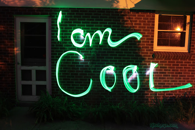 A light painting on bricks that says "I am cool".