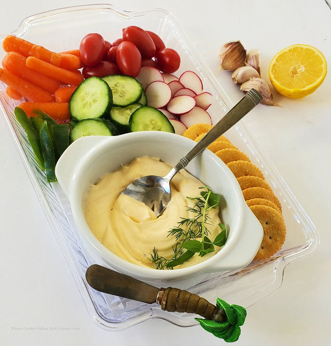 this is an aioli dip with fresh vegetables and crackers