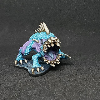 blue and purple dog fish thing with light blue scales, purple skin, and way too many teeth