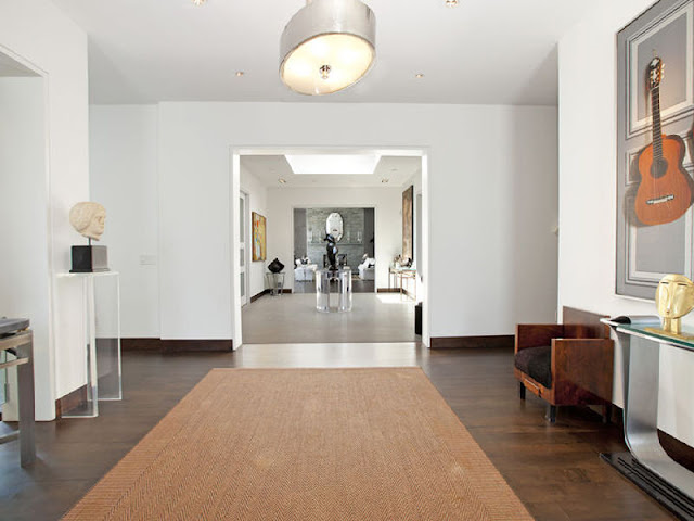 foyer in the Hamptons with wood floors and  woven chevron rug