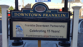 The sign acknowledges the work of the Downtown Partnership to foster the renovations downtown