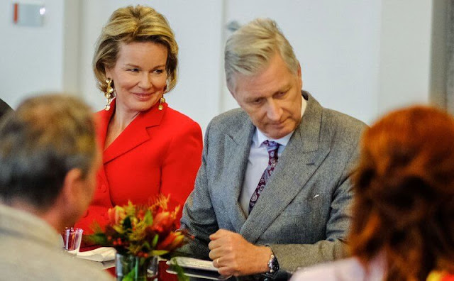 Queen Mathilde wore a red double-breasted blazer by Natan, and red trousers by Natan. Beige fur coat