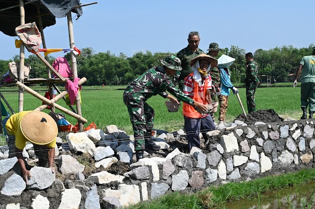 Cuaca Terik tidak menyurutkan warga dan Satgas TMMD Kodim 0726/Sukoharjo lanjutkan pekerjaan Talud Jalan.