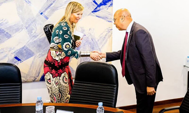 Queen Maxima wore a multicolor foulard print long sleeve crepe de chine dress by Valentino. Silver bracelet and silver Tizerzai fibula