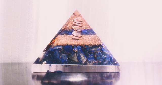 blue crystal pyramid on the desk