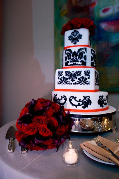 Black vase centerpiece with crystals and red flowers wedding florist and 