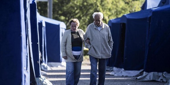 A man and a woman walk at a tent city set up after the earthquake in central Italy, Amatrice, 25 August 2016. The provisional death toll from Wednesday's earthquake in central Italy has risen to 247, the civil protection agency said Thursday. 
ANSA/ANGELO CARCONI