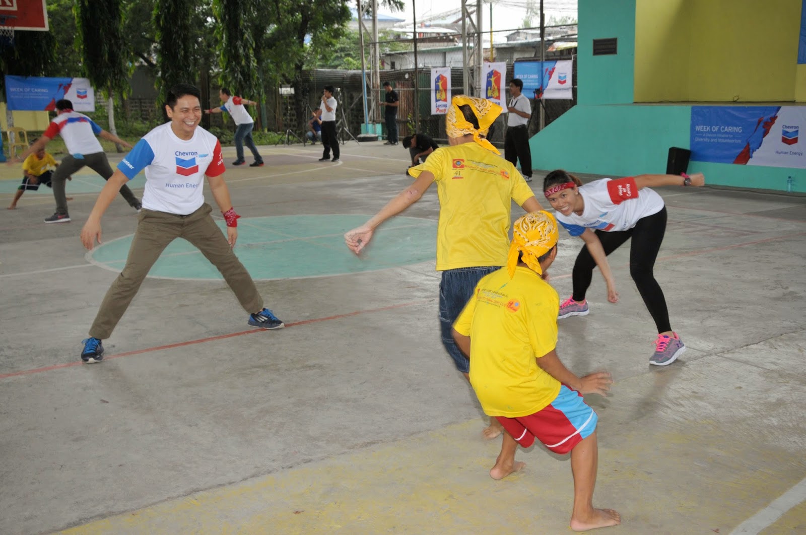 Orphans playing with Chevron volunteers