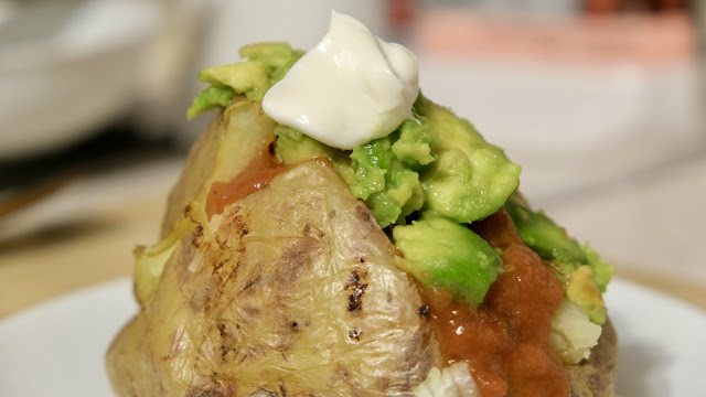 Jacket potato with salsa, avocado and vegan mayo topping