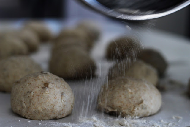 Sprinkling Flower over Rolls before Baking