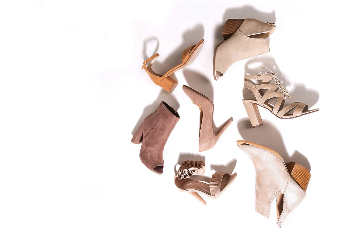 flatlay of assorted women shoes with white background