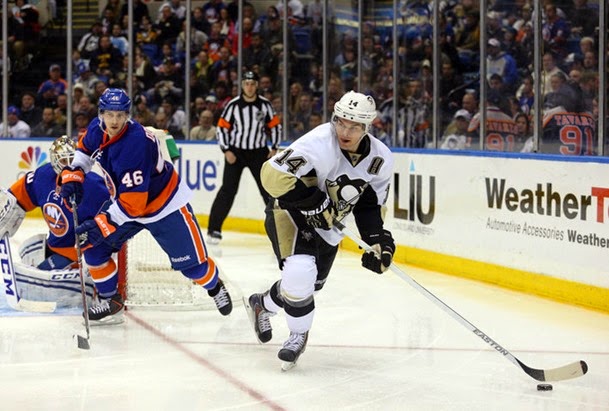 Jan 23, 2014; Uniondale, NY, USA; Pittsburgh Penguins left wing Chris Kunitz (14) controls the puck in front of New York Islanders defenseman Matt Donovan (46) during the third period of a game at Nassau Veterans Memorial Coliseum. The Penguins defeated the Islanders 6-4. Mandatory Credit: Brad Penner-USA TODAY Sports