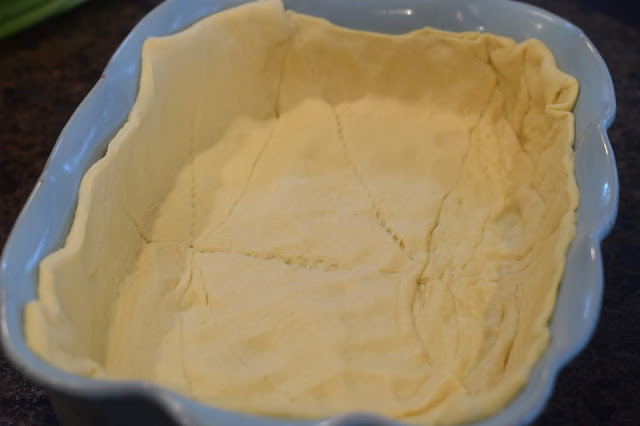 The canned crescent rolls lining a baking dish.