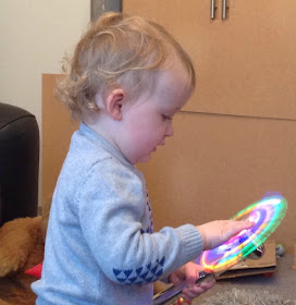 toddler playing with glow stick windmill