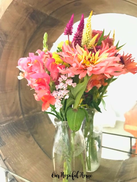 round wooden farmhouse mirror vintage milk bottle vase fresh cut flowers