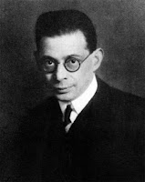Black-and-white photo of a man with glasses