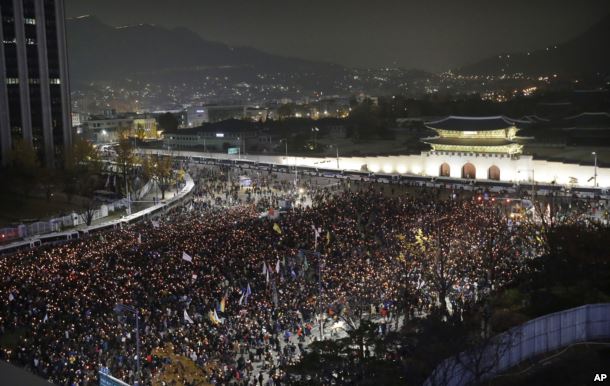 FILE - South Korean protesters march toward the presidential house during a rally calling for South Korean President Park Geun-hye to step down in Seoul, South Korea, Nov. 19, 2016.