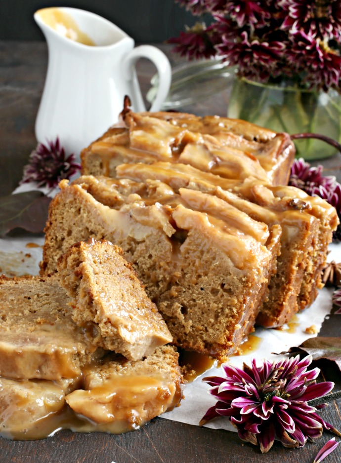 Recipe for a gingerbread loaf cake topped with thinly sliced baked pears and drizzled with homemade salted caramel sauce.