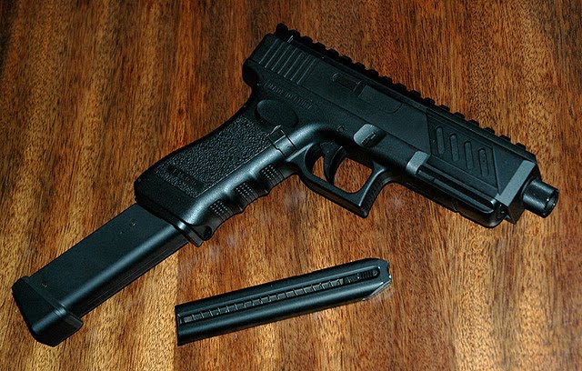 A GLOCK PISTOL WITH EXTENDED MAGAZINE, BEAUTIFUL BUT DEADLY.