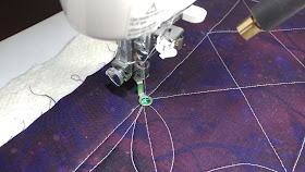 Using a dot laser for free-motion quilting accuracy