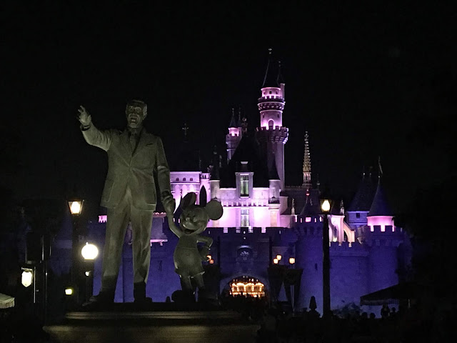 Partners Statue at Night with Sleeping Beauty Castle in the Background