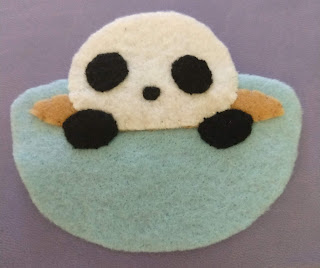 Panda hands, eyes, and nose added to teacup body