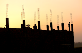 silhouette of construction with sunset in the background 