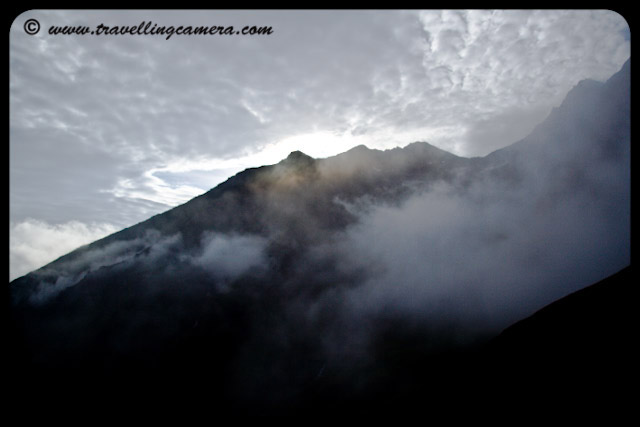 Good Morning Clouds @ Shrikhand Mahadev, Kullu Himachal Pradesh: Posted by VJ @ www.travellingcamera.com: During my 5 days of trekking to Shrikhand, Clouds around us played different games ... but we enjoyed most of them :)  Most of the times, morning starts with nice sunshine and most of the space is covered by clouds after 1 Hr ... visibility starts decreasing after 8 am.... After 12 noon, these clouds start playing hide and seek and show difference colors on mountains... I was able to capture some details in early morning because its more clear in morning as compared to other day times...It was a great experience to see fast moving clouds from one region of mountains to other... We also experienced views when it was raining on the other end which was approximately 300 meters away from dry area where we were just waiting it to stop :)  We were thinking that, its gonna rain on us in next few seconds... Weather on the way was very unpredictable.Clouds moving up from deep areas between these hills... This is very early morning shot and finally they assemble on the top and rain.. finally Sun comes to get your cloths dry... Clouds roaming around hill-tops during evening time... After 5 pm, density of these clouds decreases and most of the region around you isPartial lighting on hills due to clouds... visible to enjoy clear sunset...Clouds, Trek, Shimla, Shrikhand Mahadev, Clouds, Hill Stations, Hills, Snow Covered Hills,green, Sunrise, Sunset, rains, 