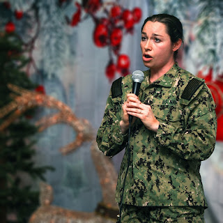 As a member of USU's a cappella group, the Dermatones, Ensign Margaret Black performs at the annual Christmas concert in 2019. (Photo credit: Ensign Margaret Black, USU)