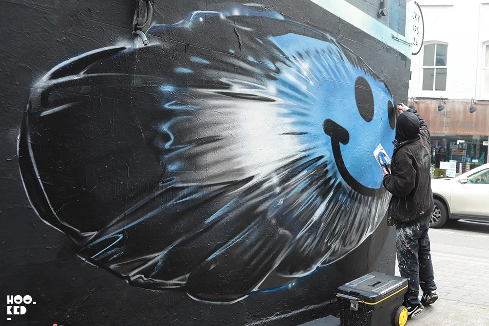 Artist Fanakapan at work on a 3D graffiti mural in London