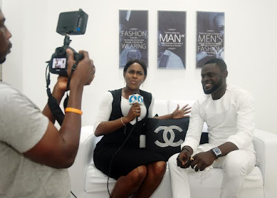 deigner yomi casual being interviewed at the Lekki shop