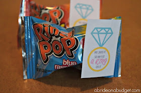 Need a FUN and EASY engagement party favor? Make these "He Liked It So He Put A Ring On It" DIY Ring Pop Engagement Party Favors from www.abrideonabudget.com. PLUS, get the printable for FREE.