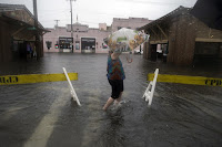 Walking in flooded street (Credit: AP Photo/Stephen B. Morton) Click to Enlarge.