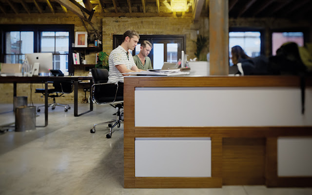 Picture of people working on the desks 