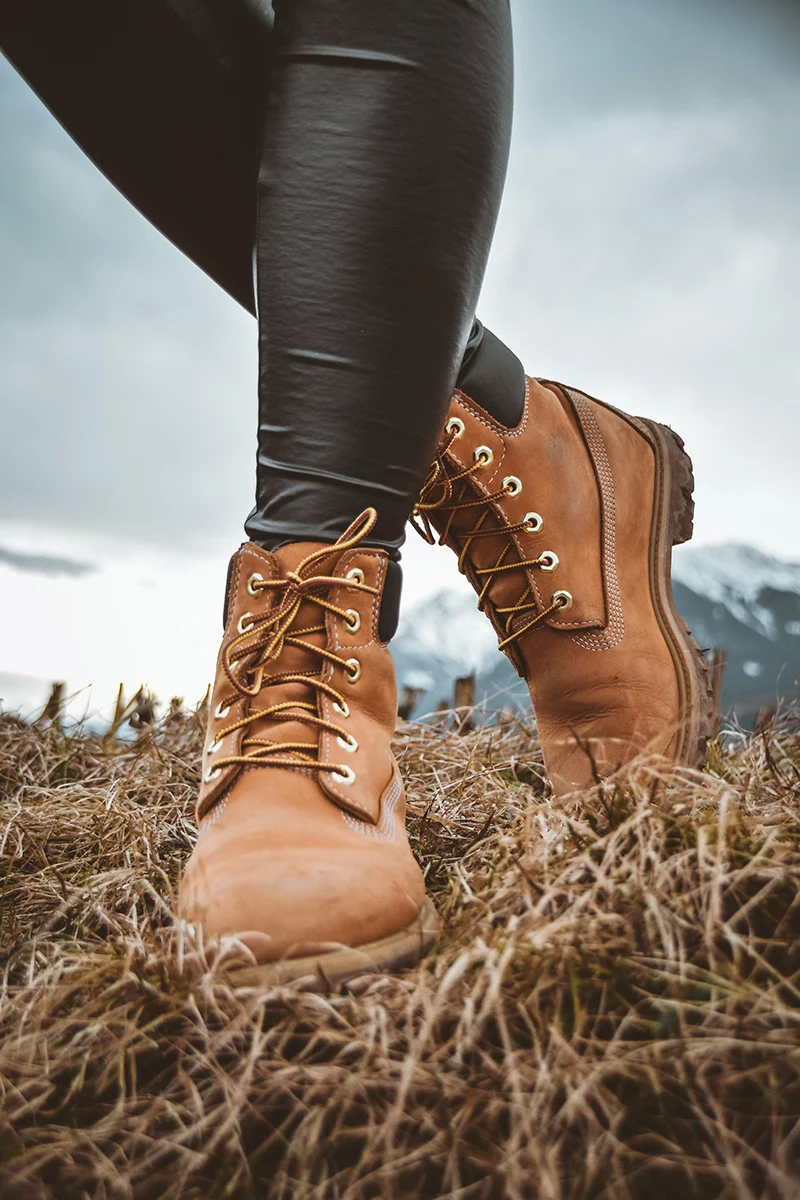 close-up of women's legs wearing brown combat boots